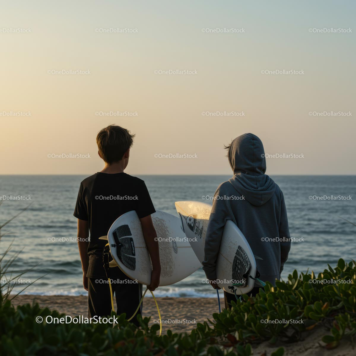 Surfers at Sunset on a Peaceful Beach