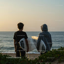 Surfers at Sunset on a Peaceful Beach