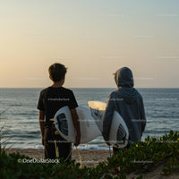 Surfers at Sunset on a Peaceful Beach