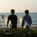 Two Young Surfers Watching Sunset by the Ocean