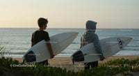 Two Boys with Surfboards at Sunset Beach