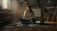 Young Woman Studying Papers at Home in Cozy Living Room