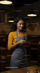 Smiling Barista Using Tablet in Cozy Coffee Shop