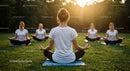 Women Meditating Outdoors at Sunset in a Grassy Park