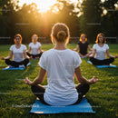 Women Meditating Outdoors at Sunset in a Grassy Park