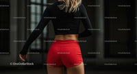 Athletic Woman in Red Shorts Preparing for Outdoor Workout