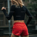 Athletic Woman in Red Shorts Preparing for Outdoor Workout