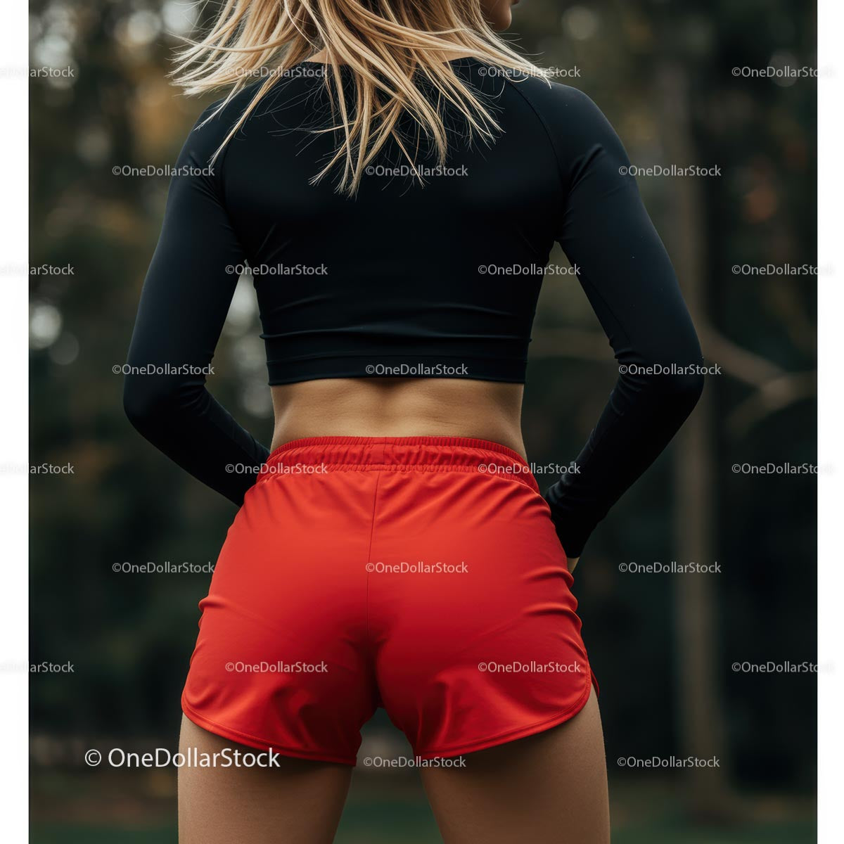 Athletic Woman in Red Shorts Preparing for Outdoor Workout