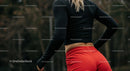 Athletic Woman in Red Shorts Preparing for Outdoor Workout
