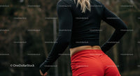 Athletic Woman in Red Shorts Preparing for Outdoor Workout