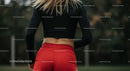 Athletic Woman in Red Shorts Preparing for Outdoor Workout