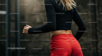 Athletic Woman in Motion with Red Shorts and Black Top