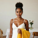 Elegant Woman in White Dress Holding Yellow Garment