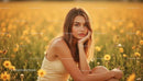 Young Woman Enjoying Peaceful Moment in Daisy Field