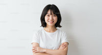Smiling Woman in Casual White T-Shirt Against White Background