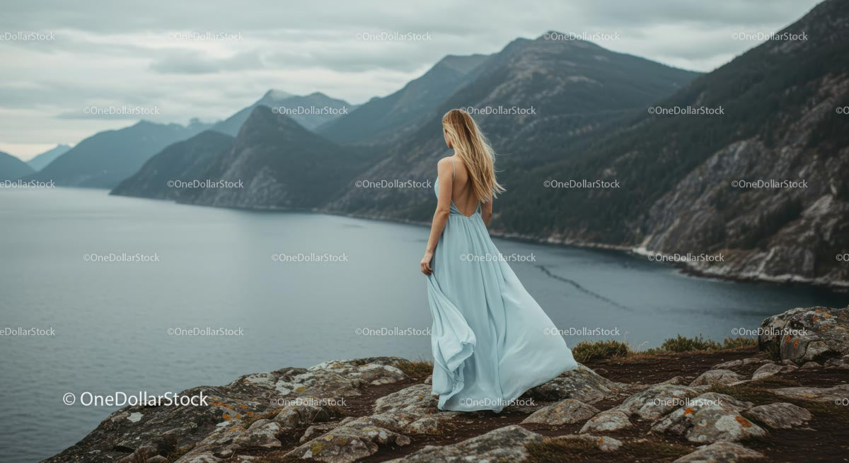 Woman in Blue Dress Overlooking Mountain Lake