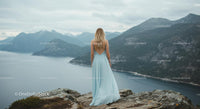 Woman in Blue Dress Overlooking Mountainous Landscape