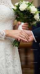 Romantic Wedding Moment with Bride and Groom Holding Hands