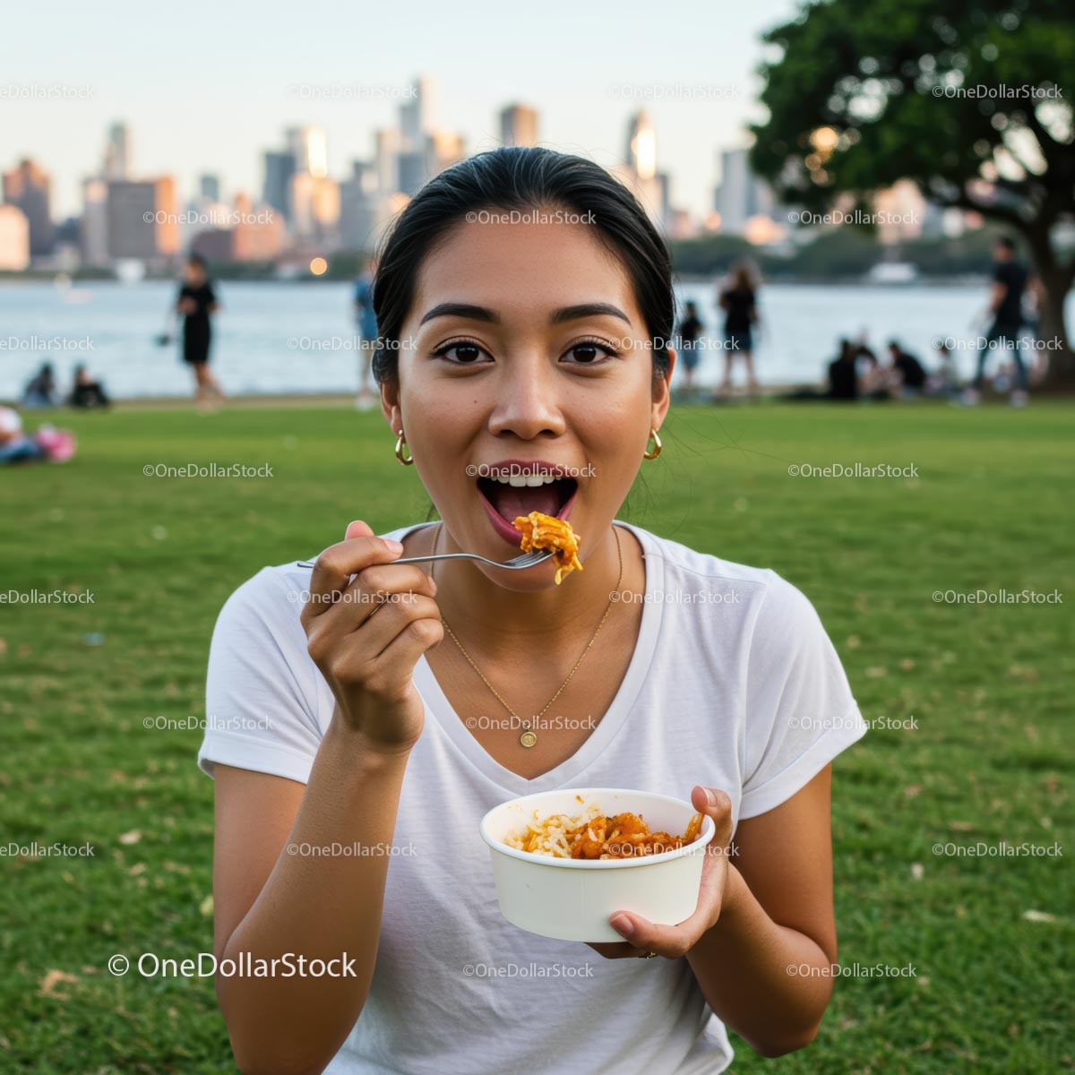 Woman Enjoying a Meal in an Urban Park with City Skyline