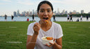 Woman Enjoying a Meal in a Vibrant Urban Park Setting