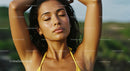 Serene Woman Enjoying Sunlight Outdoors in Yellow Bikini