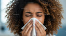 Woman Sneezing Into Tissue with Curly Hair