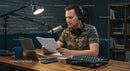 Man in Camo Shirt Recording Podcast in Professional Studio