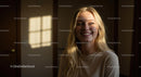 Smiling Blonde Woman in Sunlit Room
