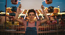 Expressive Youth Holding Sign at Amusement Park
