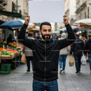 Man Holding Blank Sign in Vibrant City Market