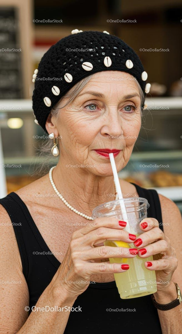 Stylish Elderly Woman Sipping a Refreshing Lemon Drink