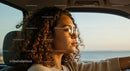 Young Woman Driving at Sunset with Sunglasses