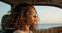 Young Woman Driving at Sunset with Sunglasses