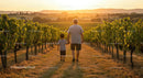Father and Son Walking Through Vineyard at Sunset