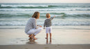 Mother and Child Exploring a Serene Beach