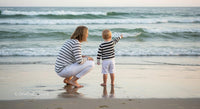 Mother and Child Exploring a Serene Beach