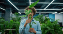 Person Holding Monstera Leaf in Modern Office