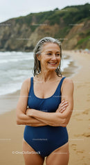 Mature Woman Smiling on the Beach in a Blue Swimsuit