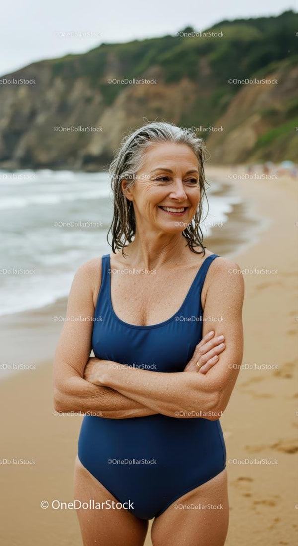 Mature Woman Smiling on the Beach in a Blue Swimsuit