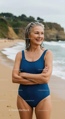 Smiling Woman Enjoying a Day at the Beach in a Blue Swimsuit