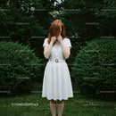 Redhead Woman in White Dress Amidst Lush Greenery
