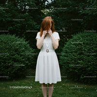 Redhead Woman in White Dress Amidst Lush Greenery