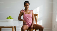 Woman in Pink Romper Relaxing in Modern Interior