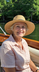 Elderly Woman in Straw Hat Enjoying a Sunny Day on a Boat