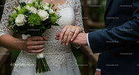 Bride and Groom Holding Hands with Floral Bouquet