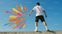 Colorful Splash Against Blue Sky with Man in Casual Outfit