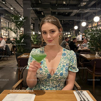 Woman Enjoying Green Cocktail in Chic Restaurant Setting