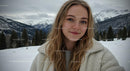 Smiling Woman in Winter Wonderland with Snow-Capped Mountains