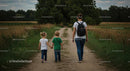 Family Walking on a Country Path Amidst Lush Greenery