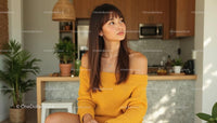 Woman in Yellow Sweater Relaxing in Stylish Kitchen